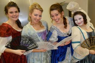 Amie Bjorklund with cast members in period costumes
